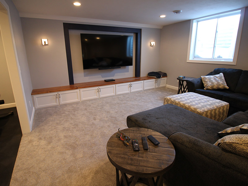 home theater installed on a remodeled basement with a tv mounted on a wall appleton wi