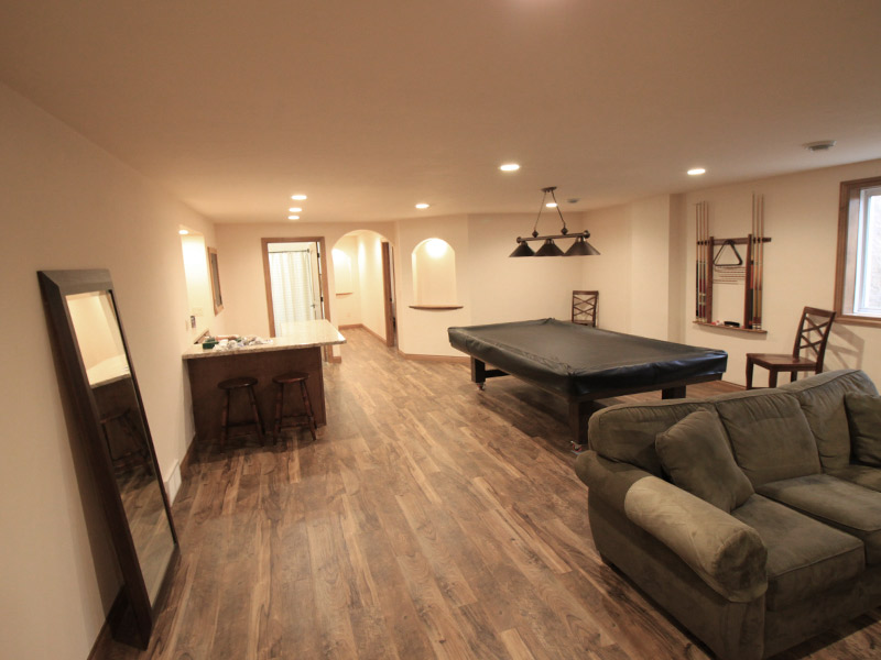 remodeled basement with a sofa a kitchenette and pool table appleton wi